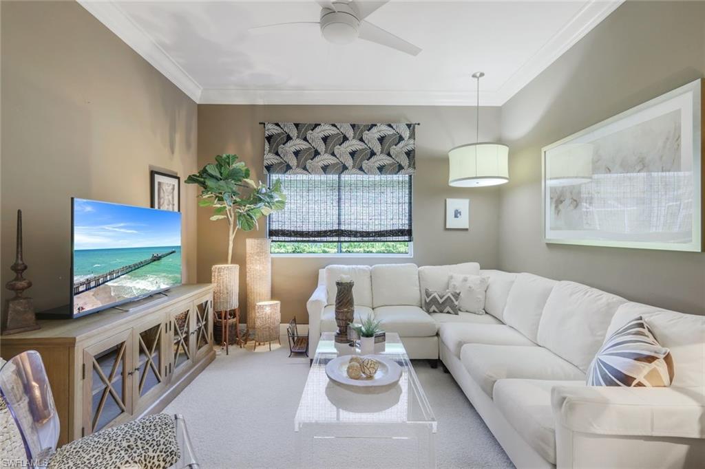 8475 Gleneagle Way Naples, FL 34120 - Photo 20 of 46 a living room with furniture and a flat screen tv