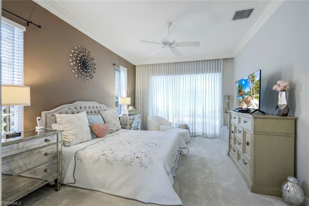8475 Gleneagle Way Naples, FL 34120 - Photo 22 of 46 a bedroom with a bed and a dresser