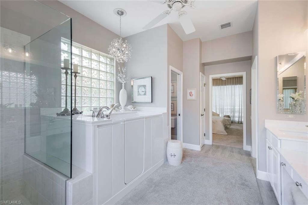 8475 Gleneagle Way Naples, FL 34120 - Photo 26 of 46 a bathroom with a double vanity sink a mirror and a shower