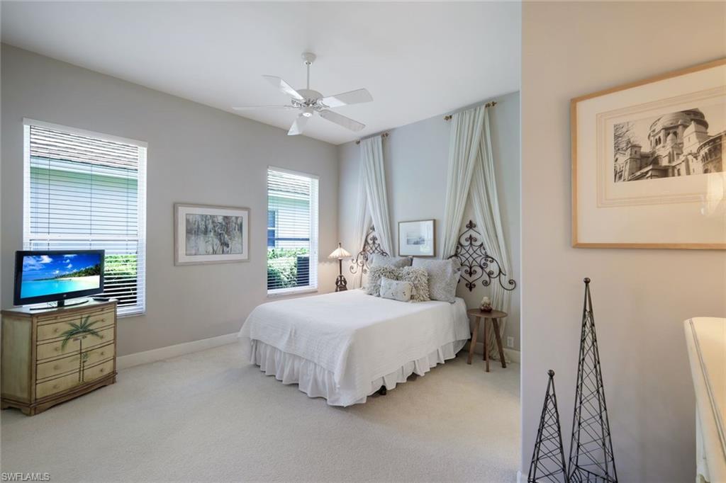 8475 Gleneagle Way Naples, FL 34120 - Photo 27 of 46 a bedroom with a bed and a flat screen tv