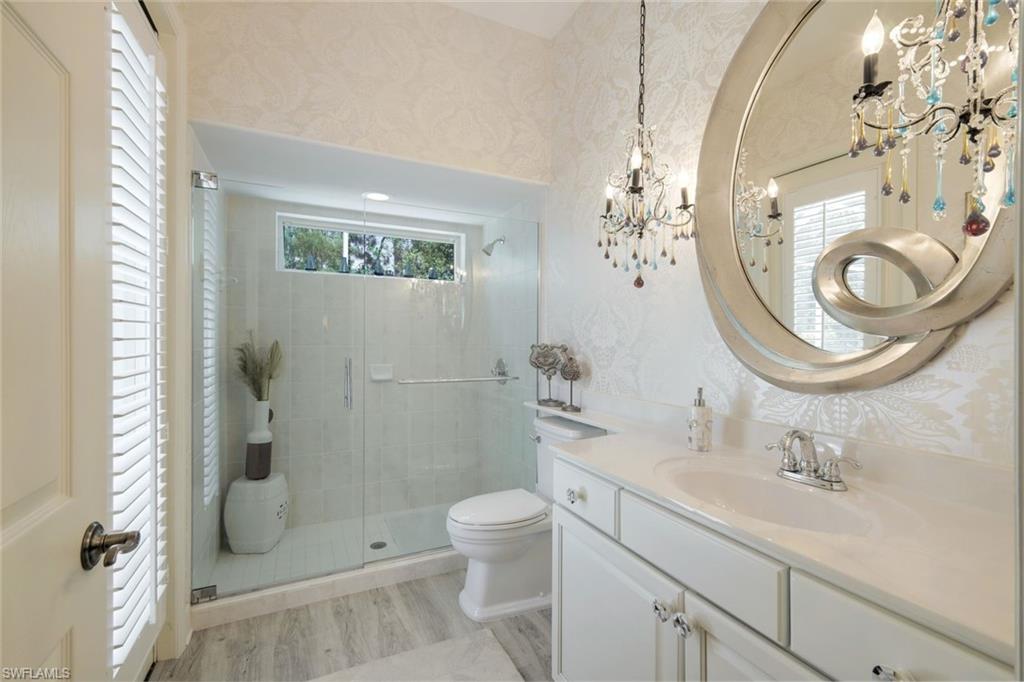 8475 Gleneagle Way Naples, FL 34120 - Photo 28 of 46 a bathroom with a toilet a sink and a mirror