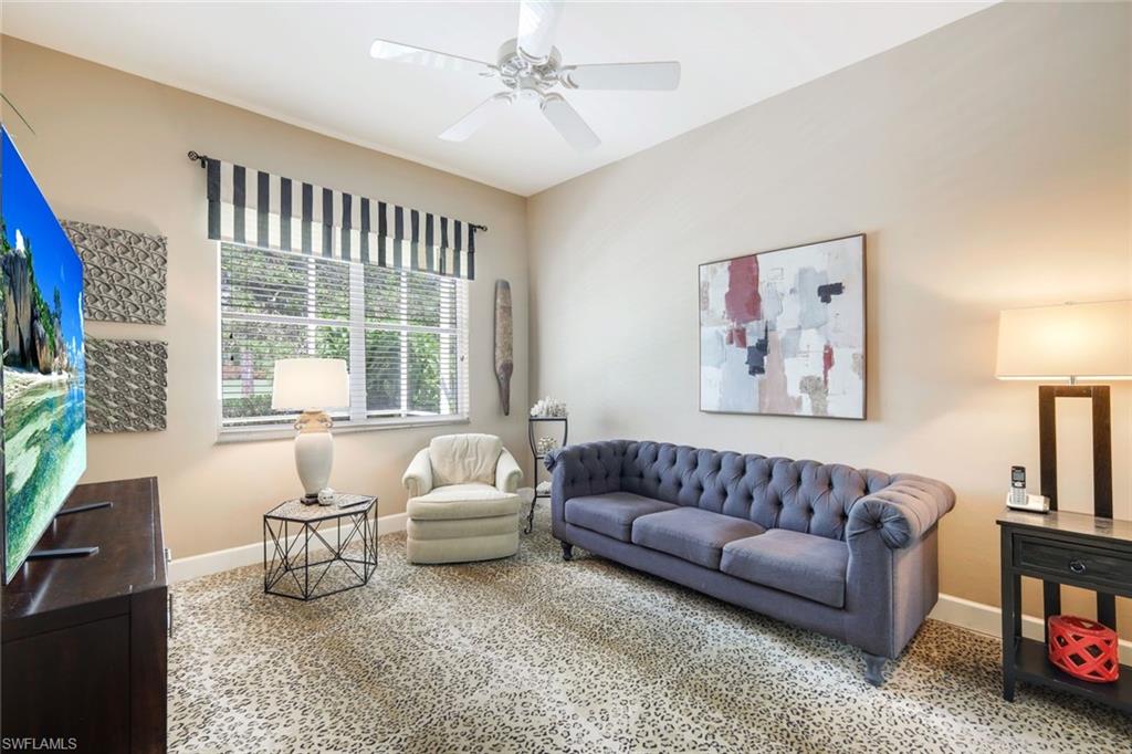 8475 Gleneagle Way Naples, FL 34120 - Photo 29 of 46 a living room with furniture and a large window