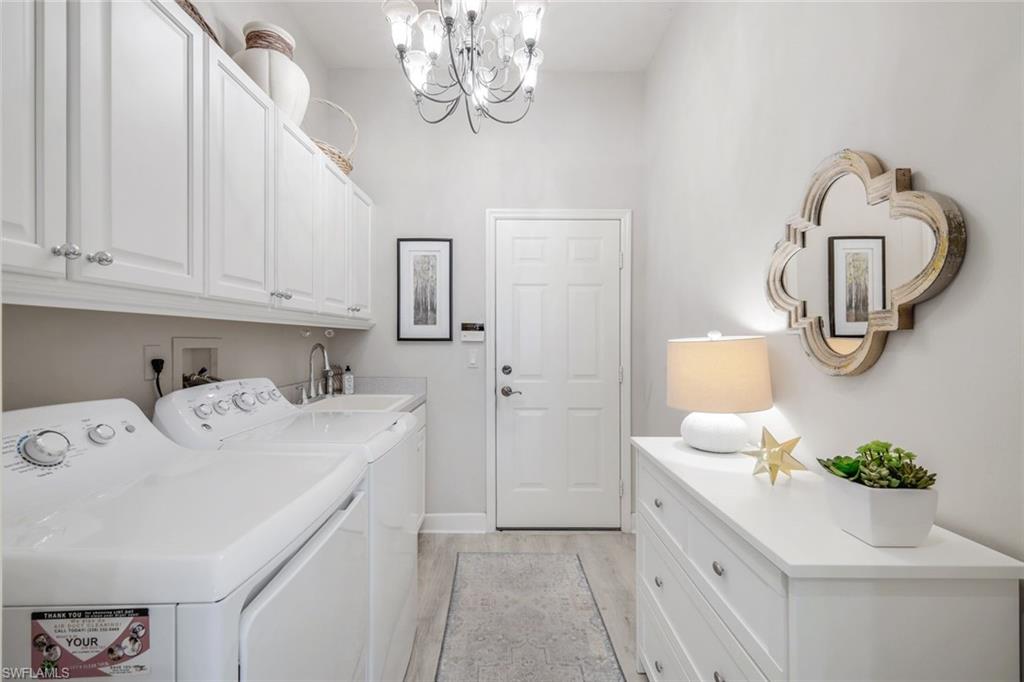 8475 Gleneagle Way Naples, FL 34120 - Photo 31 of 46 a bathroom with a sink and a mirror