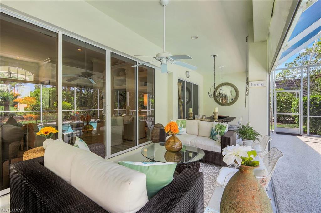 8475 Gleneagle Way Naples, FL 34120 - Photo 33 of 46 a living room with patio furniture and a large window