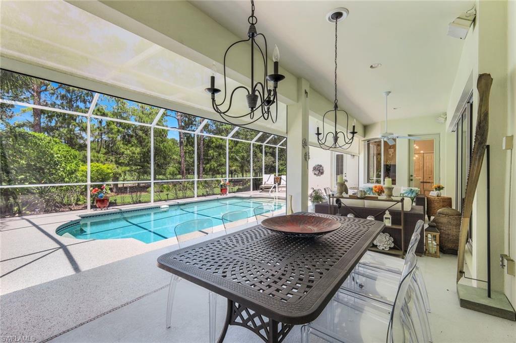 8475 Gleneagle Way Naples, FL 34120 - Photo 38 of 46 a view of a livingroom with furniture and floor to ceiling window