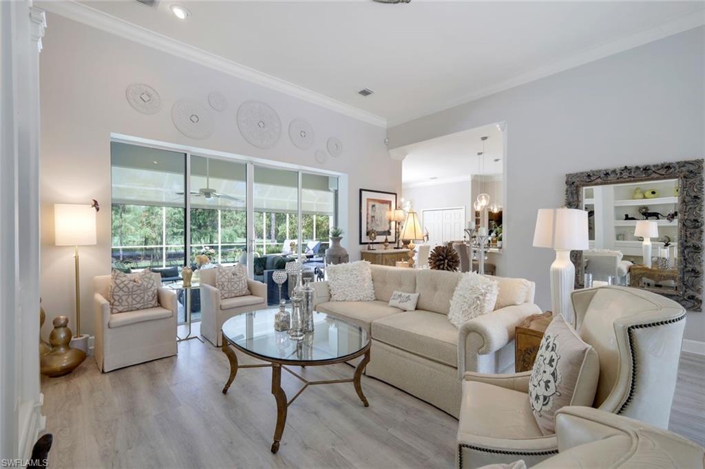 8475 Gleneagle Way Naples, FL 34120 - Photo 4 of 46 a living room with furniture and a large window