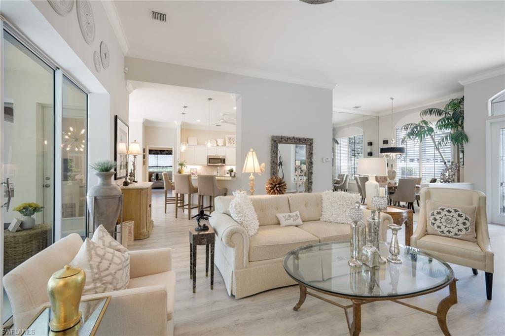 8475 Gleneagle Way Naples, FL 34120 - Photo 9 of 46 a living room with furniture and a table