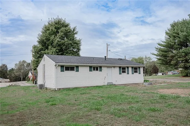 a view of a house with yard and a garden