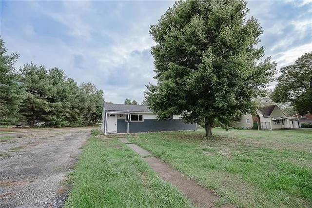 a view of house with backyard