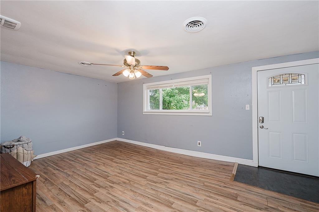191 Bear Creek Road Sarver, PA 16055 - Photo 4 of 25 an empty room with wooden floor chandelier fan and windows
