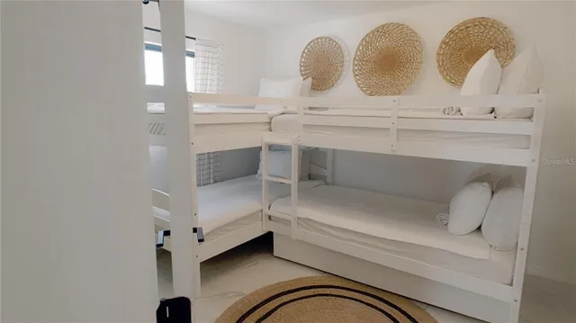 a bedroom with bed and a night stand