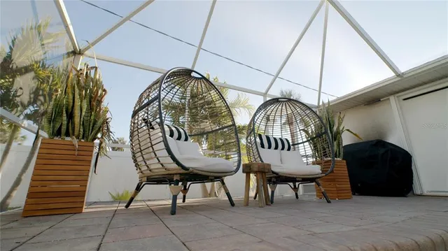 a view of a patio with iron fence