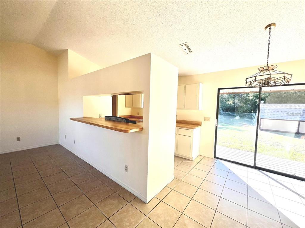 8347 Southwest 101st Place Road Ocala, FL 34481 - Photo 7 of 14 a kitchen with a sink cabinets and a living room view