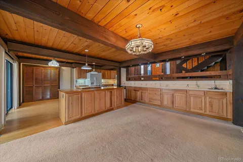 a large kitchen with a table and chairs