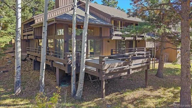 a view of a house with backyard porch and sitting area
