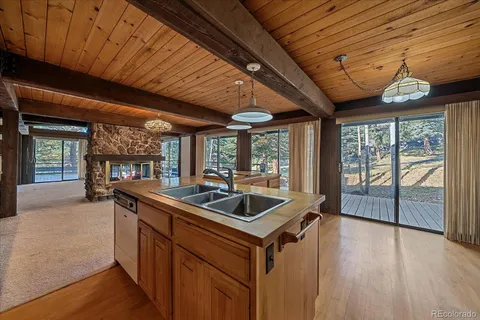 a kitchen with stainless steel appliances granite countertop a sink and wooden floors