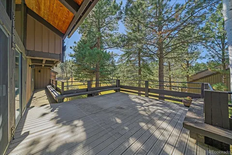 a view of backyard with deck and wooden floor