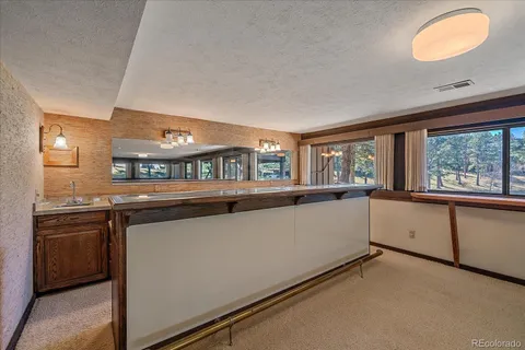 a dining room with a wooden table and chairs