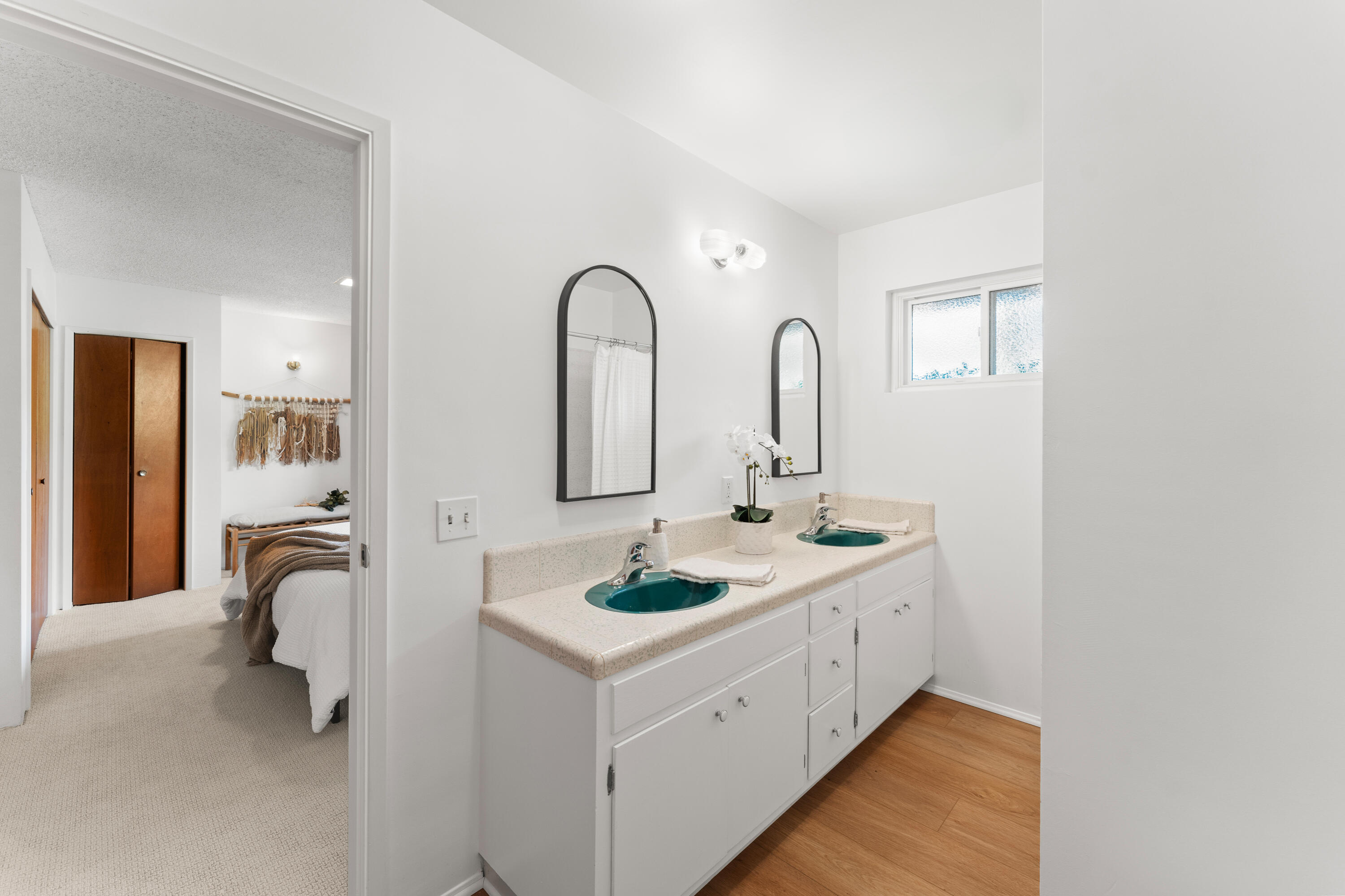 3919 Antone Road Santa Barbara, CA 93110 - Photo 24 of 38 a bathroom with a double vanity sink and a mirror