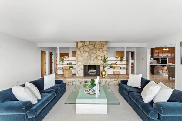 a living room with furniture and a fireplace