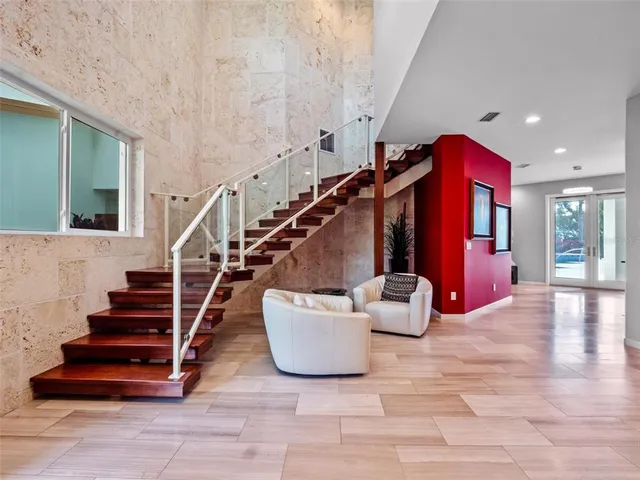 a kitchen with stainless steel appliances kitchen island granite countertop a sink table and chairs