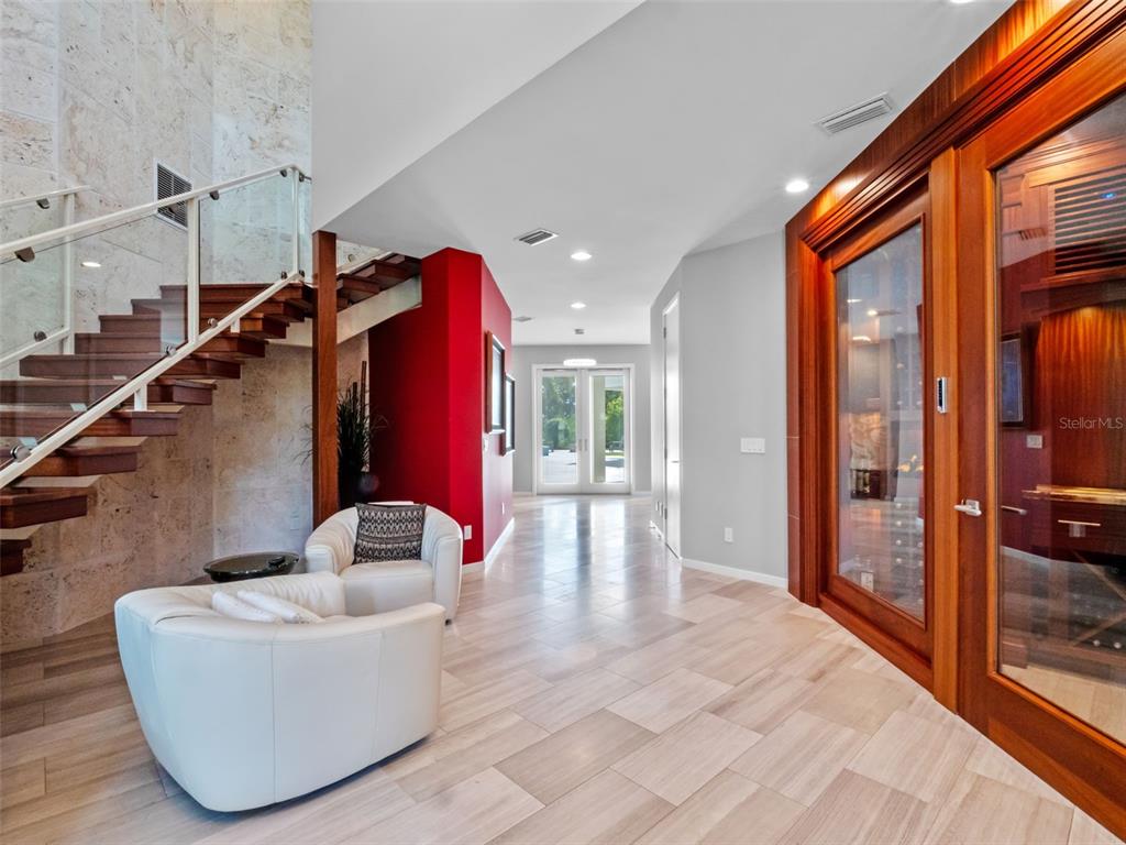 1511 South Riverside Drive New Smyrna Beach, FL 32168 - Photo 18 of 81 a hallway with a couch and front door