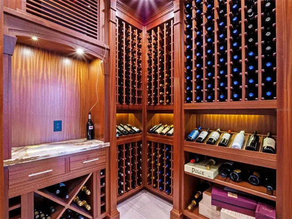 a kitchen with center island counter top space a sink stainless steel appliances and windows