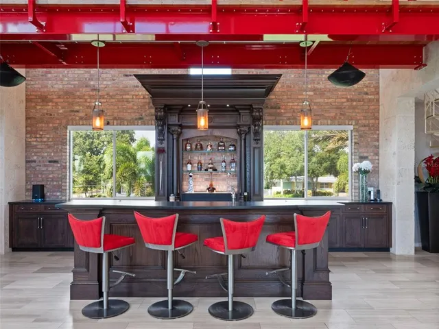 a spacious bedroom with a bed a dresser and a chandelier