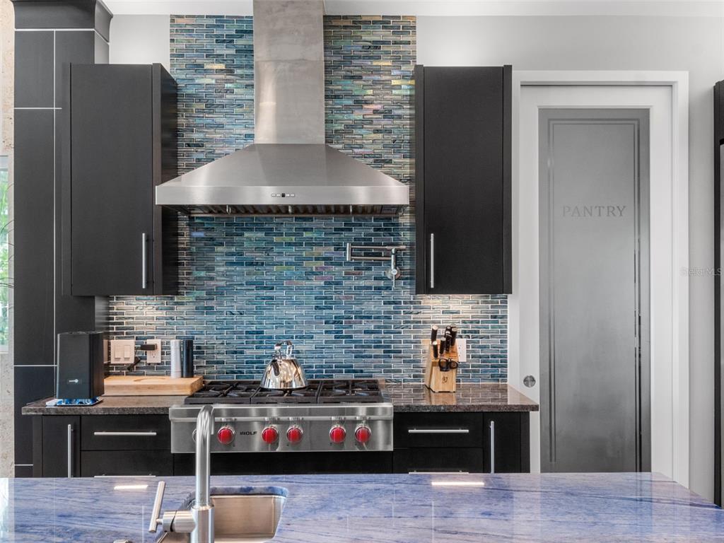 1511 South Riverside Drive New Smyrna Beach, FL 32168 - Photo 30 of 81 a kitchen with stainless steel appliances kitchen island granite countertop a refrigerator and a stove