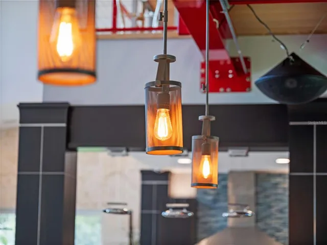a living room with patio furniture and a potted plants