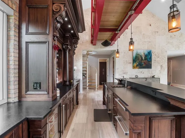 a kitchen with stainless steel appliances a stove and more cabinets