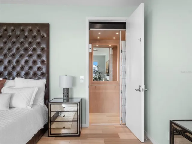 a bed sitting in a spacious bedroom next to a window