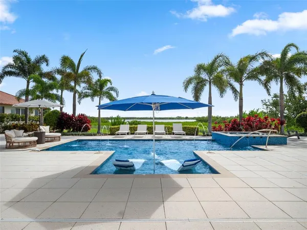 a view of a livingroom with furniture and floor to ceiling window