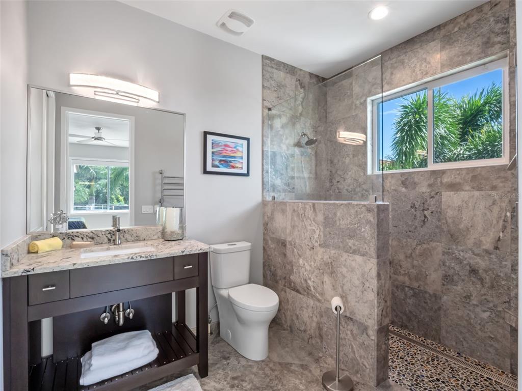 1511 South Riverside Drive New Smyrna Beach, FL 32168 - Photo 59 of 81 a bathroom with a toilet a sink and a window
