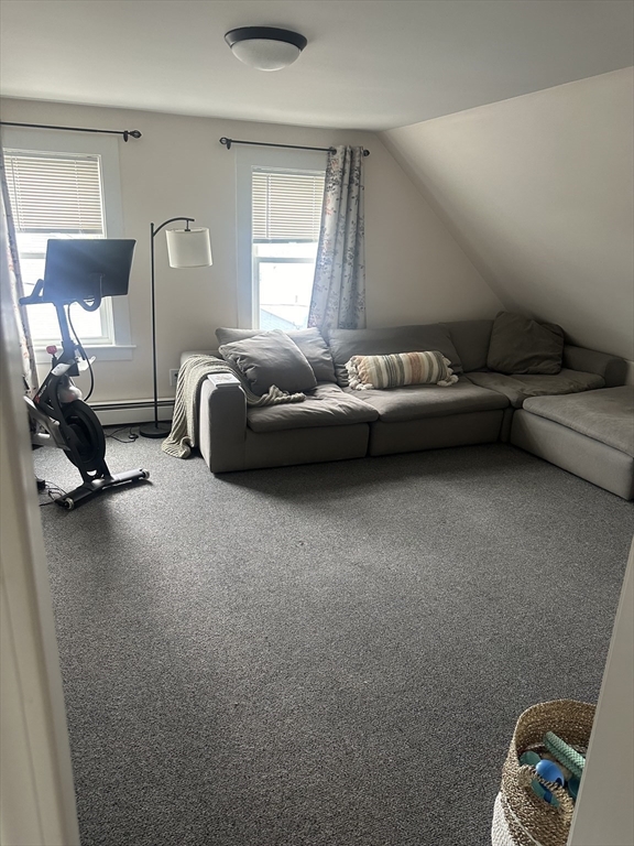 a bedroom with a bed a couch and dresser