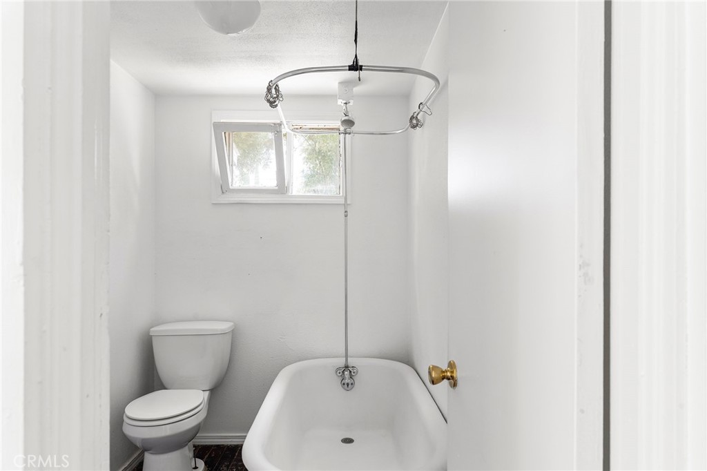 818 6th Street Corning, CA 96021 - Photo 16 of 32 a bathroom with a toilet sink and mirror