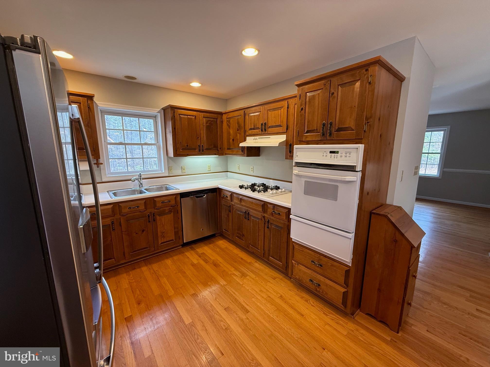 5545 Yanceyville Road Louisa, VA 23093 - Photo 17 of 64 a kitchen with wooden floors and wooden cabinets