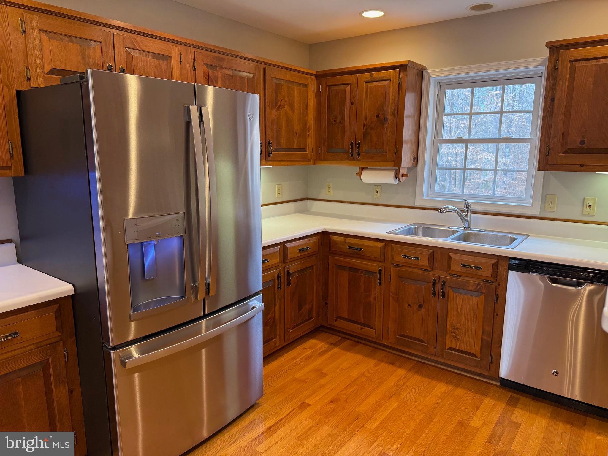 5545 Yanceyville Road Louisa, VA 23093 - Photo 18 of 64 a kitchen with stainless steel appliances granite countertop a refrigerator and a sink