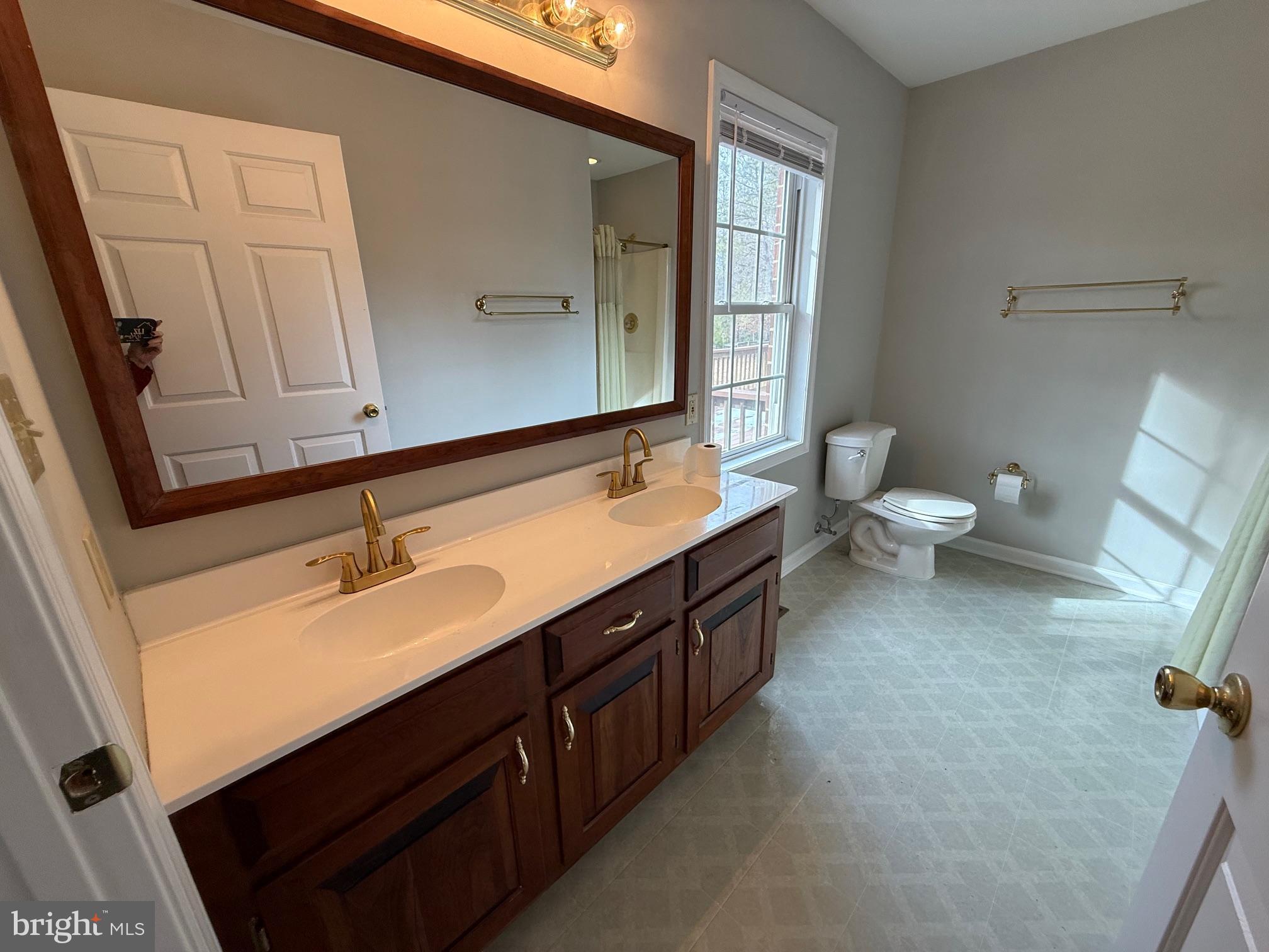 5545 Yanceyville Road Louisa, VA 23093 - Photo 33 of 63 a spacious bathroom with a double vanity sink and a mirror