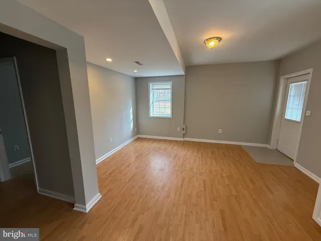 a kitchen with stainless steel appliances kitchen island granite countertop a sink a stove a refrigerator with a dining table and chairs