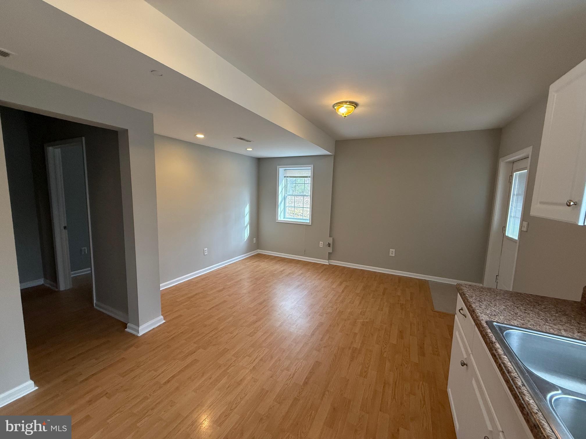 5545 Yanceyville Road Louisa, VA 23093 - Photo 41 of 64 a view of an empty room with window and wooden floor