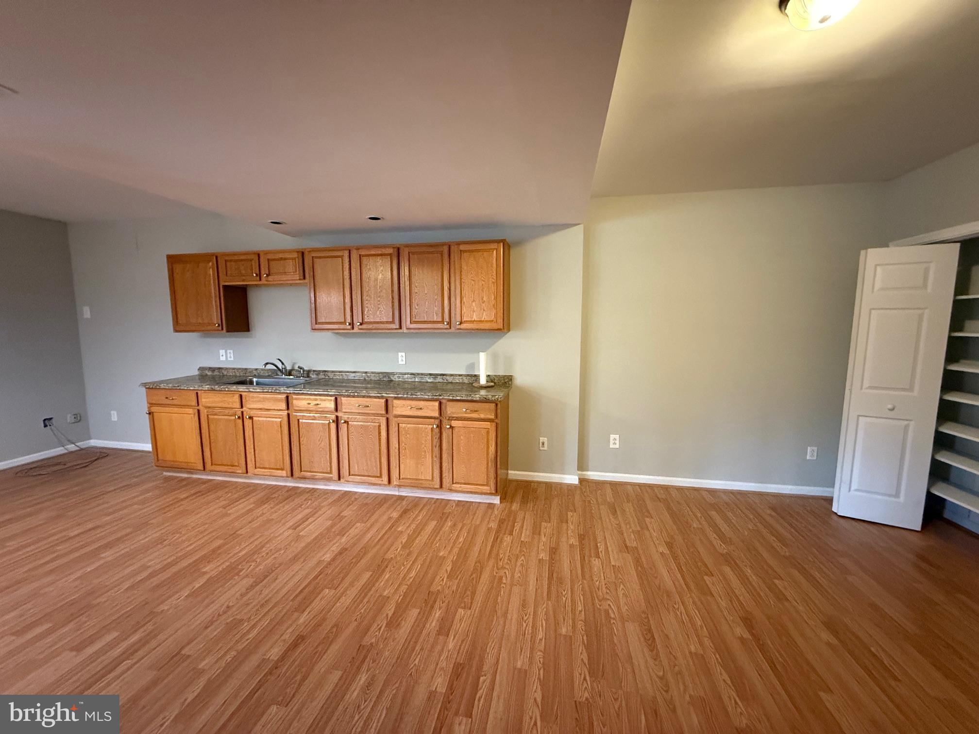 5545 Yanceyville Road Louisa, VA 23093 - Photo 46 of 63 a kitchen with granite countertop wooden floors and wide window