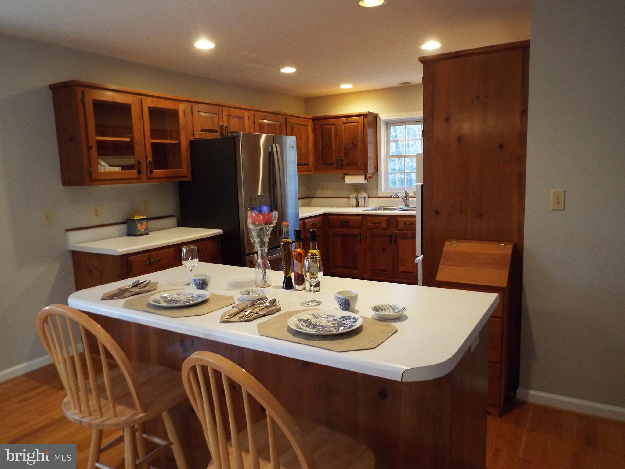 5545 Yanceyville Road Louisa, VA 23093 - Photo 53 of 64 a dining room with stainless steel appliances kitchen island granite countertop a dining table and chairs