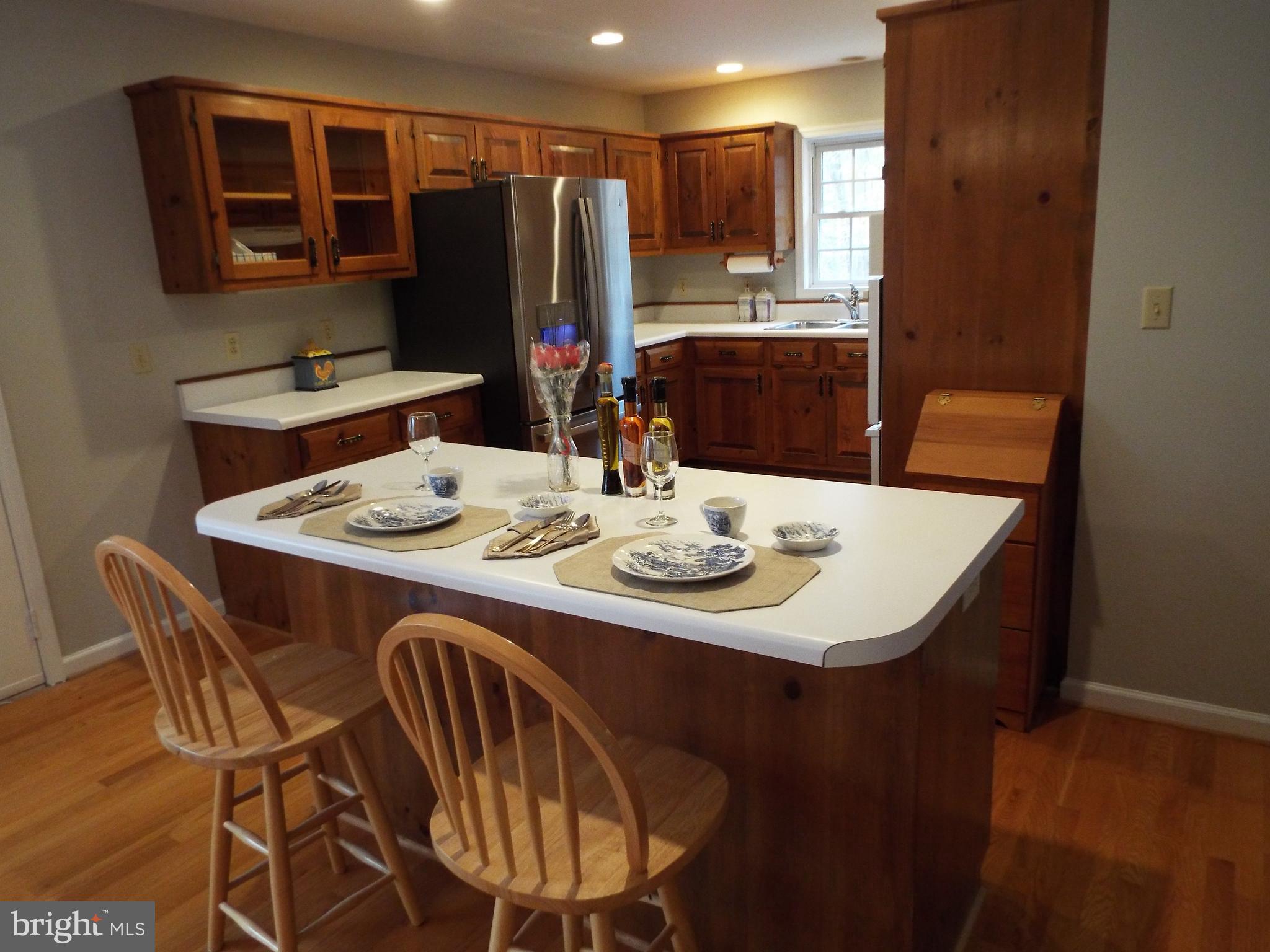 5545 Yanceyville Road Louisa, VA 23093 - Photo 58 of 64 a dining room with furniture a kitchen a chandelier and wooden floor