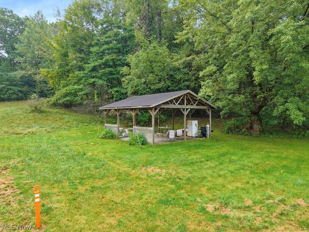 2014-2042 Merrill Road Kent, OH 44240 - Photo 13 of 26 Wood-framed gazebo with a shingled roof, set on a concrete pad with lattice detailing