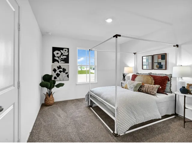 a bedroom with a bed and window