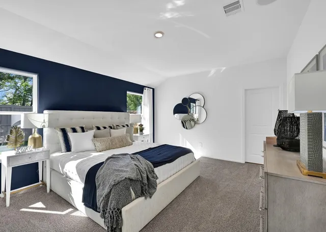 a bedroom with a bed and window