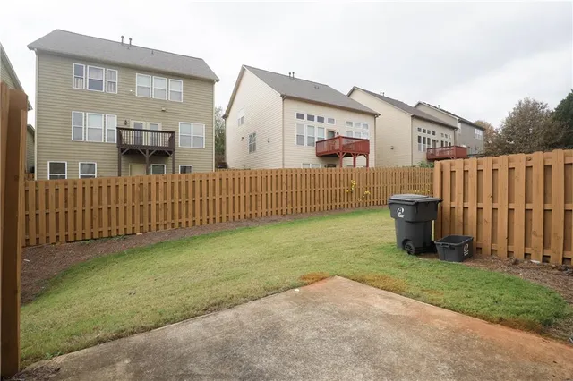 a view of backyard with a chair and table in the house