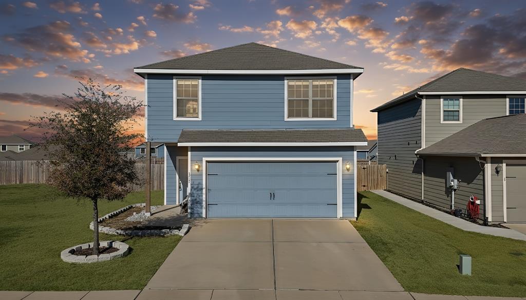 233 Lewis Lane Venus, TX 76084 - Photo 1 of 40 Twilight front exterior showcasing a charming two-story home with manicured lawn, modern color palette, and inviting curb appeal.