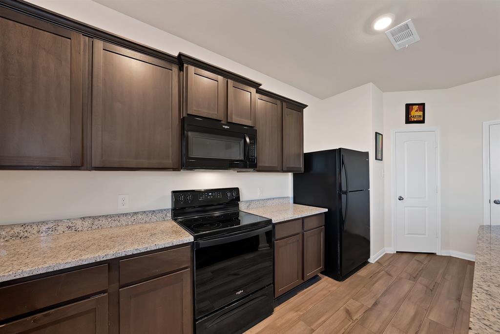 233 Lewis Lane Venus, TX 76084 - Photo 11 of 40 view of the kitchen showing the large walk in pantry door.